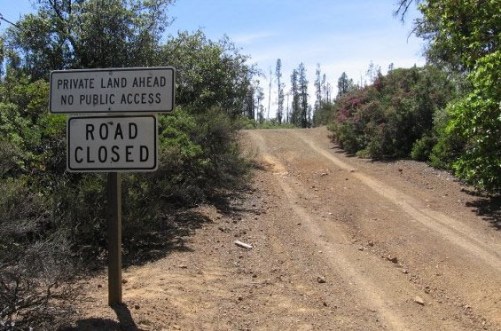 Signs: Private Land Ahead. No Public Access. Road Closed.